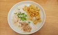 Singaporean shrimp and chicken porridge served with youtiao onion leaves